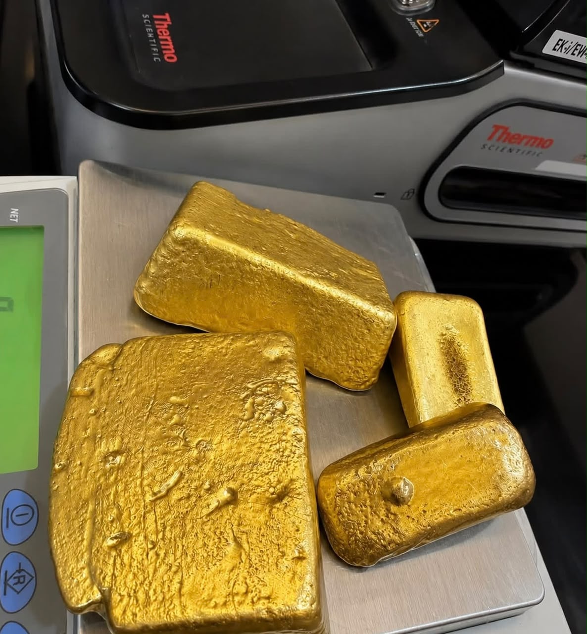 Gold bars on a precision scale